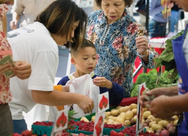Mother and son buying vegetables at Farmer's Market