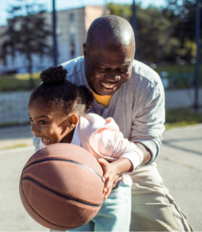Grandfather and Granddaughter playing basketball